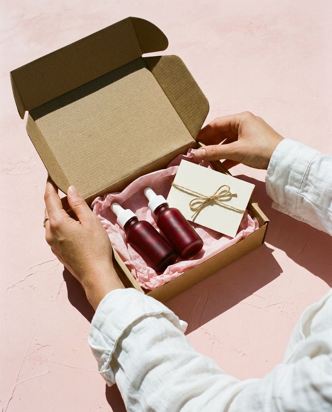 A loyalty card and the serum bottle on a pink background